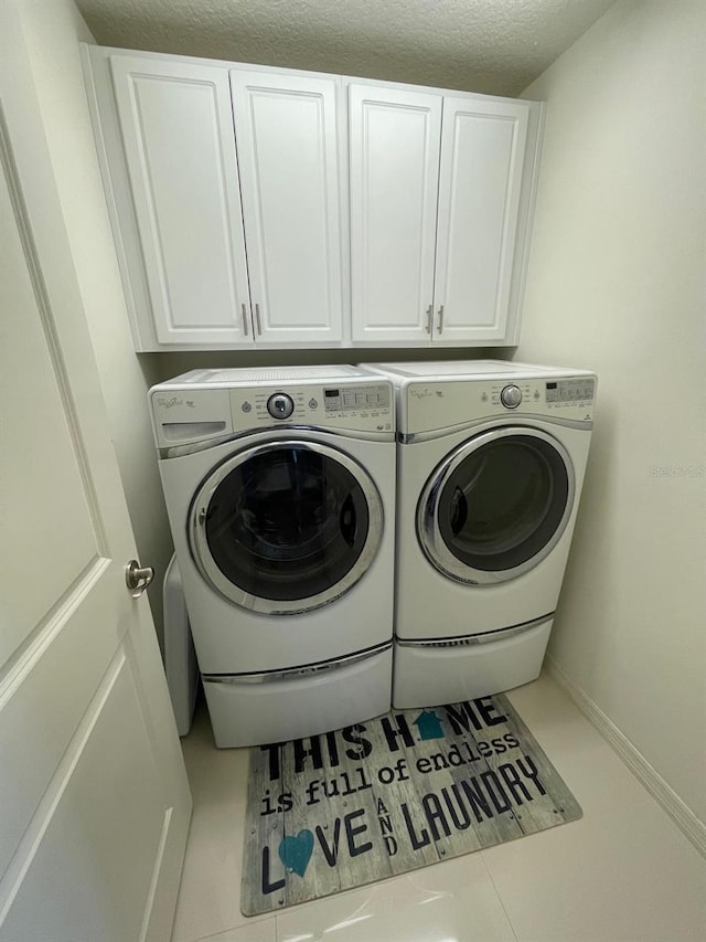 14753 Snowy Egret St, Winter Garden, FL 34787 - laundry area featuring cabinet space, washer and dryer, a textured ceiling, and baseboards