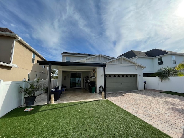 14753 Snowy Egret St, Winter Garden, FL 34787 - back of house featuring decorative driveway, an attached garage, and stucco siding