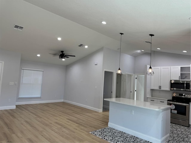 468 Marion Oaks Blvd, Ocala, FL 34473 - kitchen with appliances with stainless steel finishes, white cabinetry, a kitchen island, light countertops, and ceiling fan
