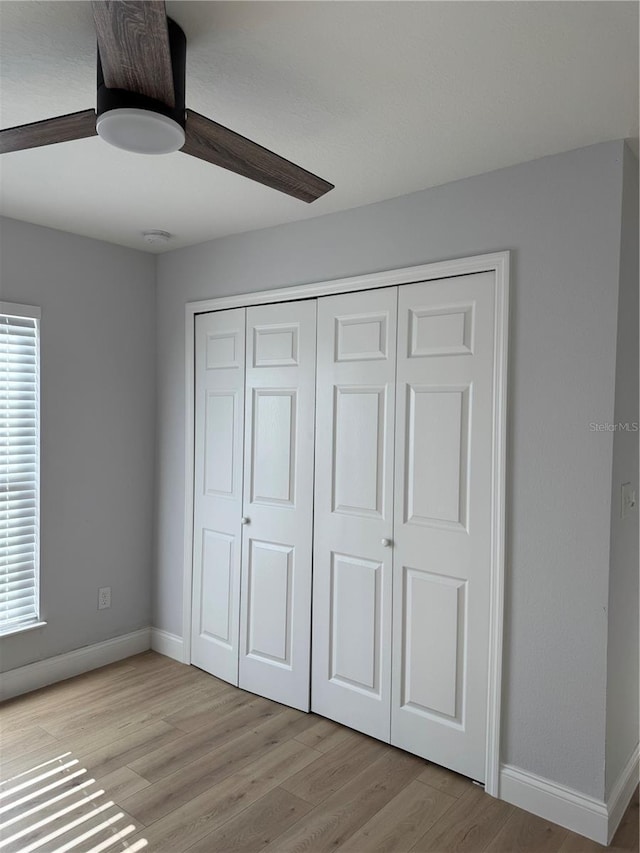 468 Marion Oaks Blvd, Ocala, FL 34473 - unfurnished bedroom featuring light wood finished floors, baseboards, a closet, and a ceiling fan