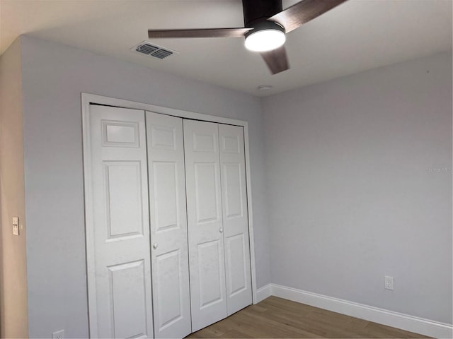 468 Marion Oaks Blvd, Ocala, FL 34473 - unfurnished bedroom featuring wood finished floors, baseboards, a closet, and a ceiling fan
