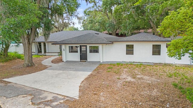 22 Hillcrest Dr, Babson Park, FL 33827 - view of front facade with concrete driveway, stucco siding, and roof with shingles