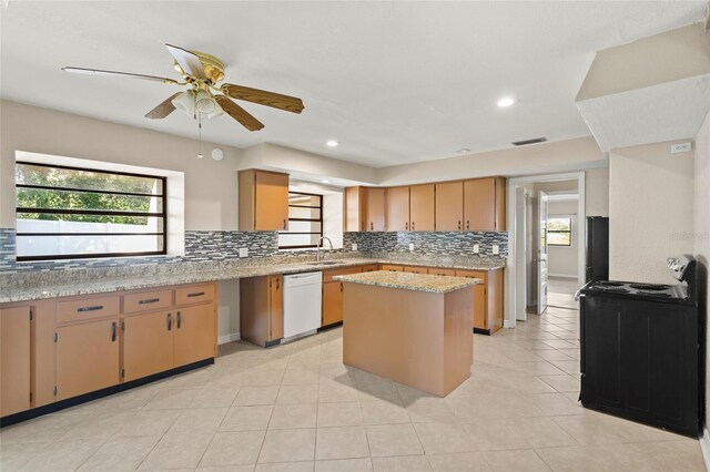 22 Hillcrest Dr, Babson Park, FL 33827 - kitchen with white dishwasher, a sink, tasteful backsplash, a kitchen island, and plenty of natural light