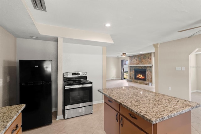 22 Hillcrest Dr, Babson Park, FL 33827 - kitchen featuring freestanding refrigerator, stainless steel electric range oven, a ceiling fan, a center island, and light tile patterned floors