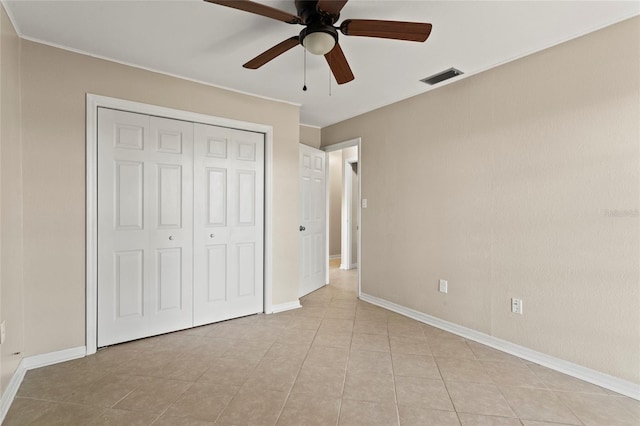 22 Hillcrest Dr, Babson Park, FL 33827 - unfurnished bedroom with a closet, light tile patterned flooring, baseboards, ceiling fan, and crown molding