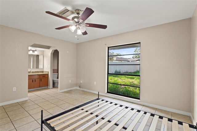 22 Hillcrest Dr, Babson Park, FL 33827 - unfurnished bedroom with light tile patterned flooring, arched walkways, and baseboards