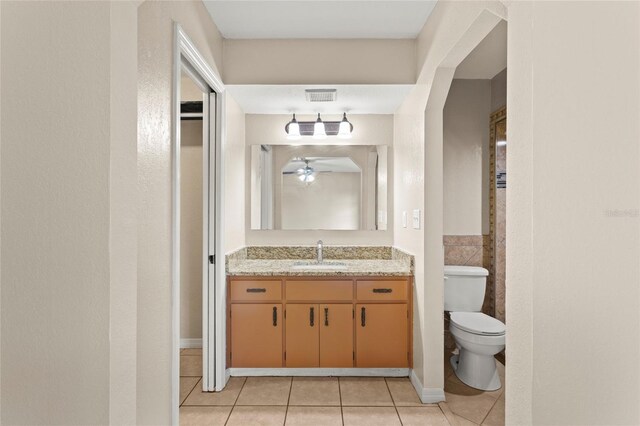 22 Hillcrest Dr, Babson Park, FL 33827 - bathroom with tile patterned flooring, vanity, toilet, and a ceiling fan