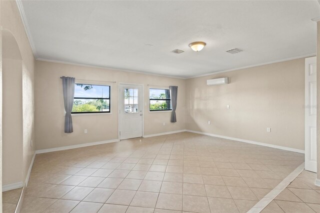 22 Hillcrest Dr, Babson Park, FL 33827 - empty room featuring crown molding, light tile patterned floors, a wall unit AC, and baseboards