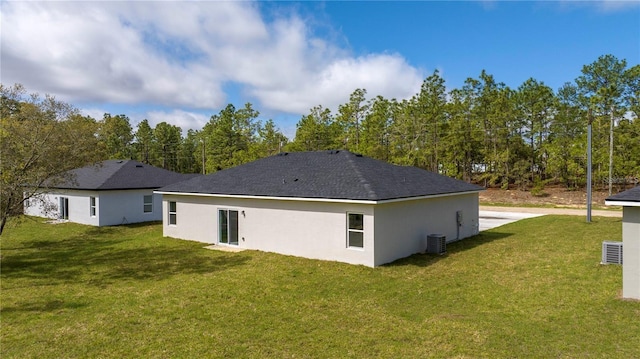 9825 N Swanee Ter, Dunnellon, FL 34433 - rear view of property featuring a yard, cooling unit, and stucco siding