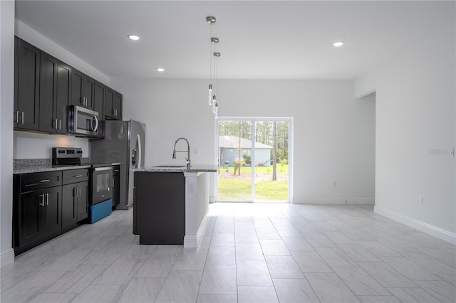 9825 N Swanee Ter, Dunnellon, FL 34433 - kitchen featuring stainless steel appliances, a sink, light stone countertops, recessed lighting, and baseboards