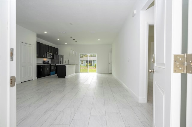 9825 N Swanee Ter, Dunnellon, FL 34433 - unfurnished living room with a sink, light marble finish flooring, recessed lighting, and baseboards