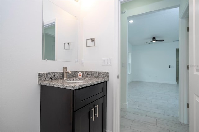 9825 N Swanee Ter, Dunnellon, FL 34433 - bathroom featuring vanity, a ceiling fan, and baseboards