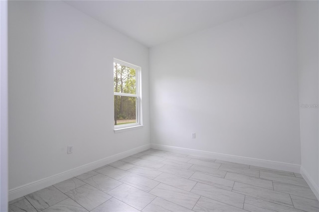 9825 N Swanee Ter, Dunnellon, FL 34433 - empty room featuring light marble finish flooring and baseboards