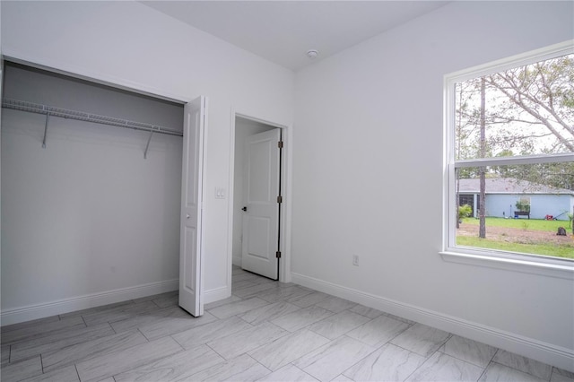 9825 N Swanee Ter, Dunnellon, FL 34433 - unfurnished bedroom featuring a closet and baseboards
