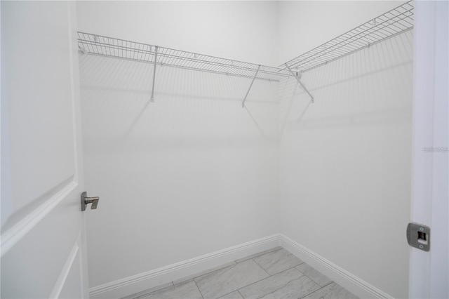 9825 N Swanee Ter, Dunnellon, FL 34433 - walk in closet featuring light marble finish floors