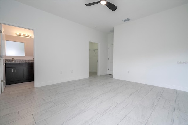 9825 N Swanee Ter, Dunnellon, FL 34433 - spare room with ceiling fan, baseboards, and a sink