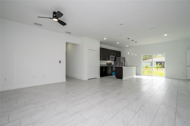 9825 N Swanee Ter, Dunnellon, FL 34433 - unfurnished living room with a ceiling fan, recessed lighting, and baseboards