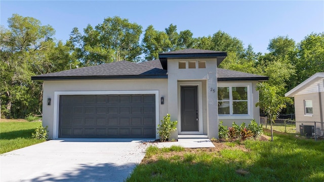 25 W 7th St, Apopka, FL 32703 - prairie-style home with stucco siding, a garage, driveway, a shingled roof, and central AC