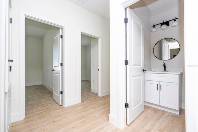 25 W 7th St, Apopka, FL 32703 - hallway featuring light wood-style floors, baseboards, and a sink