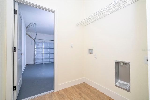 25 W 7th St, Apopka, FL 32703 - washroom with washer hookup, baseboards, light wood-style flooring, and a garage