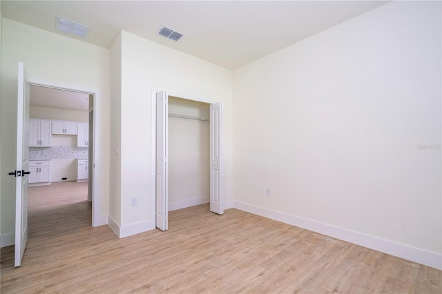 25 W 7th St, Apopka, FL 32703 - unfurnished bedroom featuring light wood-style floors, baseboards, and a closet