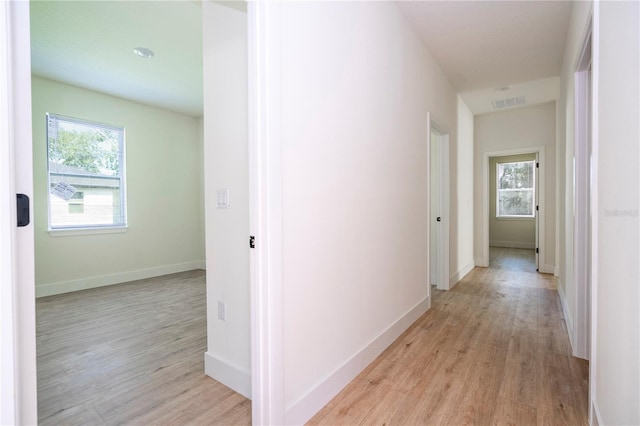 25 W 7th St, Apopka, FL 32703 - corridor with healthy amount of natural light, light wood-style floors, and baseboards