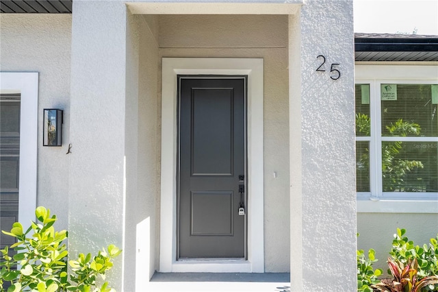 25 W 7th St, Apopka, FL 32703 - view of exterior entry featuring stucco siding