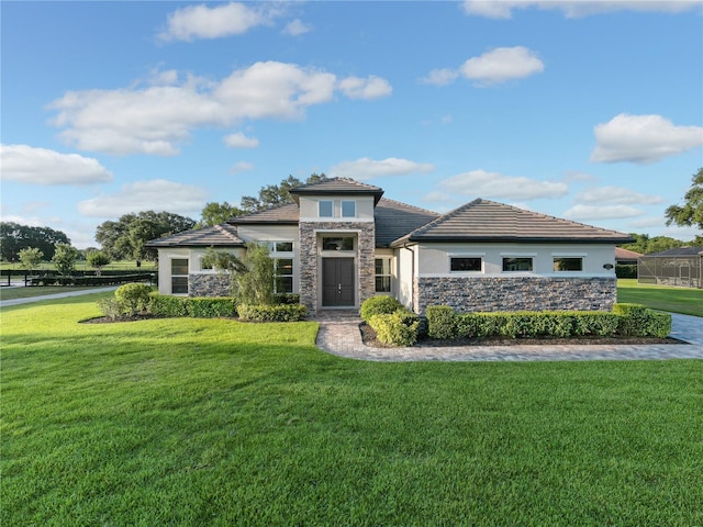 25859 Crossings Bluff Ln, Sorrento, FL 32776 - prairie-style home with stone siding, a front yard, and stucco siding