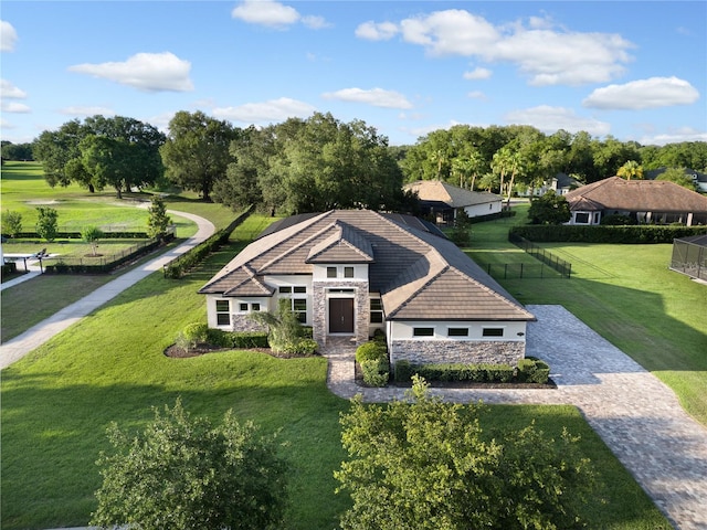 25859 Crossings Bluff Ln, Sorrento, FL 32776 - view of front of property featuring stone siding, driveway, view of scattered trees, and a tile roof