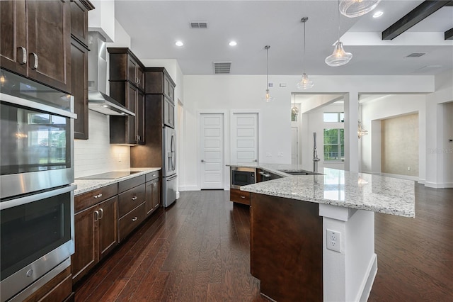 25859 Crossings Bluff Ln, Sorrento, FL 32776 - kitchen featuring appliances with stainless steel finishes, backsplash, a large island with sink, dark brown cabinets, and recessed lighting