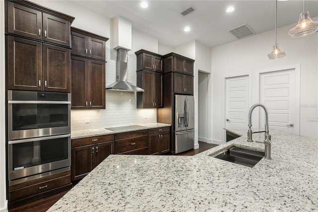 25859 Crossings Bluff Ln, Sorrento, FL 32776 - kitchen with stainless steel appliances, wall chimney exhaust hood, a sink, dark wood-style flooring, and recessed lighting