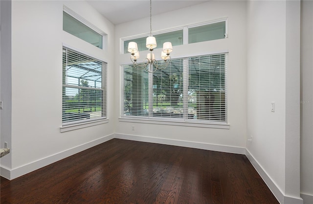 25859 Crossings Bluff Ln, Sorrento, FL 32776 - unfurnished dining area featuring a chandelier, baseboards, and dark wood finished floors