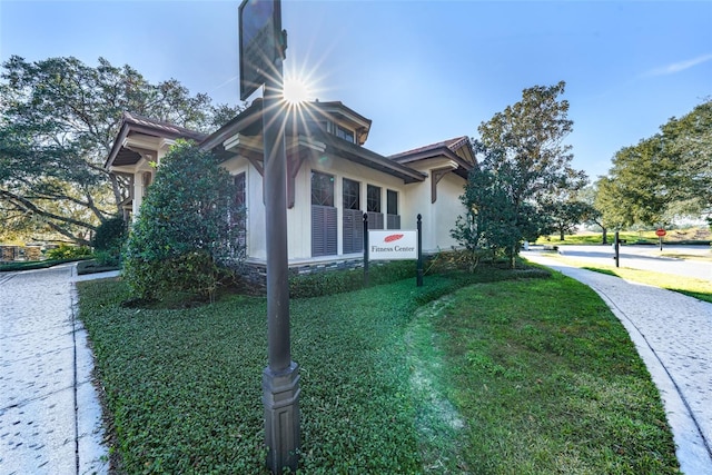 25859 Crossings Bluff Ln, Sorrento, FL 32776 - view of property exterior featuring a yard and stucco siding