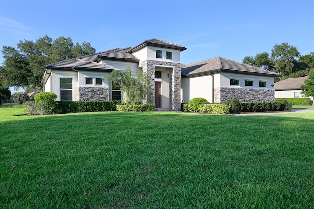 25859 Crossings Bluff Ln, Sorrento, FL 32776 - view of front of home with stone siding, stucco siding, a front lawn, and a tiled roof