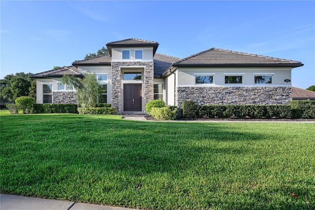 25859 Crossings Bluff Ln, Sorrento, FL 32776 - prairie-style home featuring stone siding, stucco siding, and a front lawn