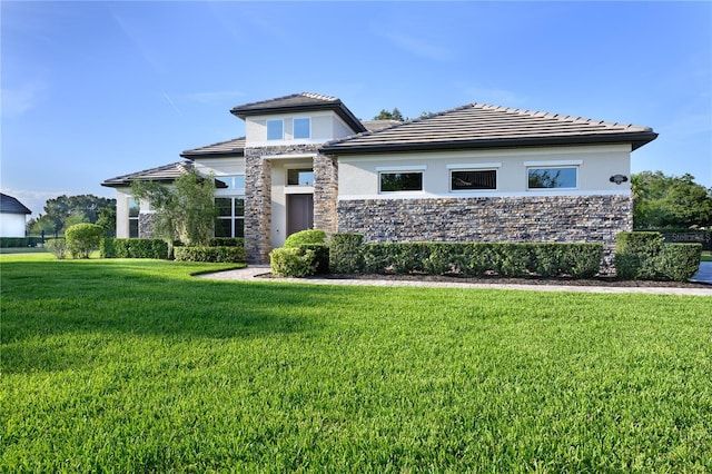 25859 Crossings Bluff Ln, Sorrento, FL 32776 - prairie-style home featuring stucco siding, a front lawn, stone siding, and a tile roof