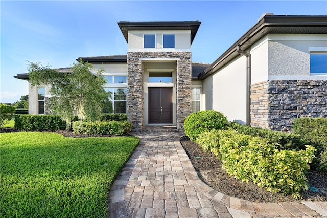 25859 Crossings Bluff Ln, Sorrento, FL 32776 - entrance to property with stucco siding, stone siding, and a lawn