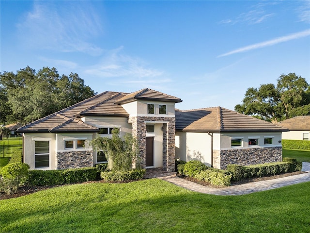 25859 Crossings Bluff Ln, Sorrento, FL 32776 - prairie-style house featuring stone siding, stucco siding, and a front lawn
