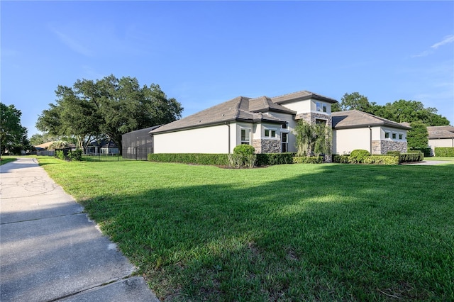 25859 Crossings Bluff Ln, Sorrento, FL 32776 - view of side of home with stone siding, stucco siding, and a yard