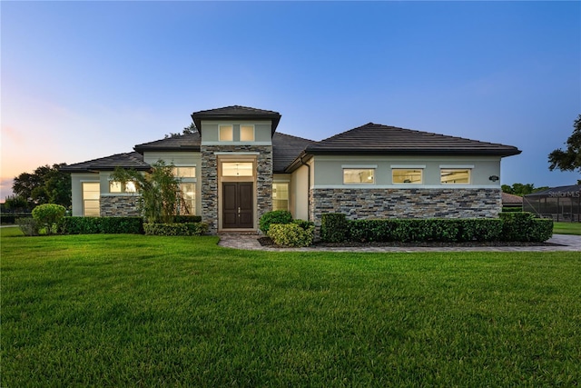 25859 Crossings Bluff Ln, Sorrento, FL 32776 - prairie-style home featuring stucco siding, stone siding, and a lawn