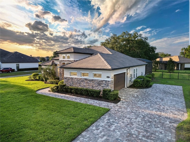25859 Crossings Bluff Ln, Sorrento, FL 32776 - view of side of property with a garage, stone siding, stucco siding, driveway, and a tiled roof
