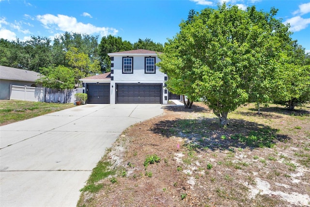 809 Deer Glen Ct, Fruitland Park, FL 34731 - view of front of house featuring concrete driveway, stucco siding, and an attached garage