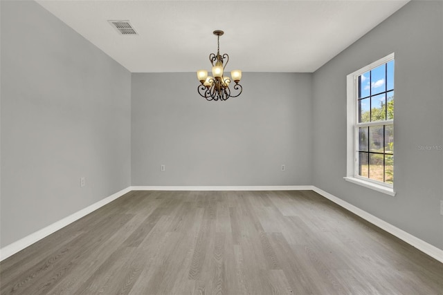 809 Deer Glen Ct, Fruitland Park, FL 34731 - unfurnished room featuring a chandelier, wood finished floors, and baseboards