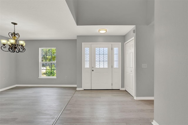 809 Deer Glen Ct, Fruitland Park, FL 34731 - entrance foyer featuring wood finished floors, a chandelier, and baseboards