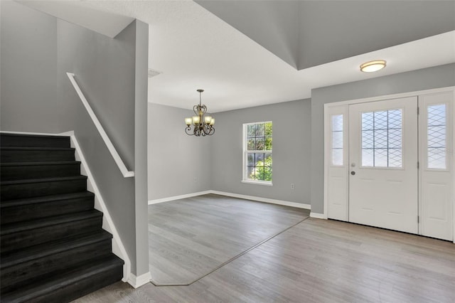 809 Deer Glen Ct, Fruitland Park, FL 34731 - entryway featuring stairway, a chandelier, wood finished floors, and baseboards