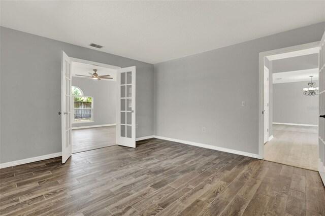 809 Deer Glen Ct, Fruitland Park, FL 34731 - empty room featuring wood finished floors, a chandelier, baseboards, and french doors