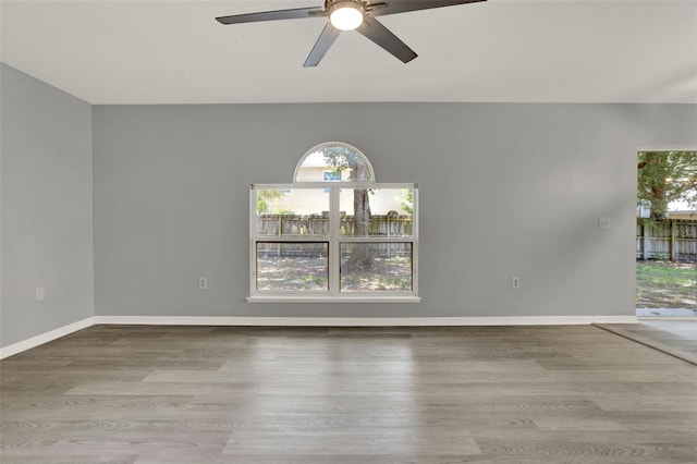 809 Deer Glen Ct, Fruitland Park, FL 34731 - empty room featuring ceiling fan, wood finished floors, and baseboards