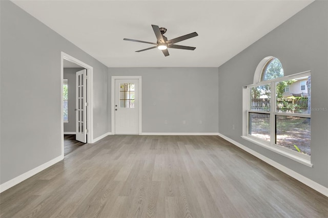 809 Deer Glen Ct, Fruitland Park, FL 34731 - empty room featuring ceiling fan, plenty of natural light, wood finished floors, and baseboards