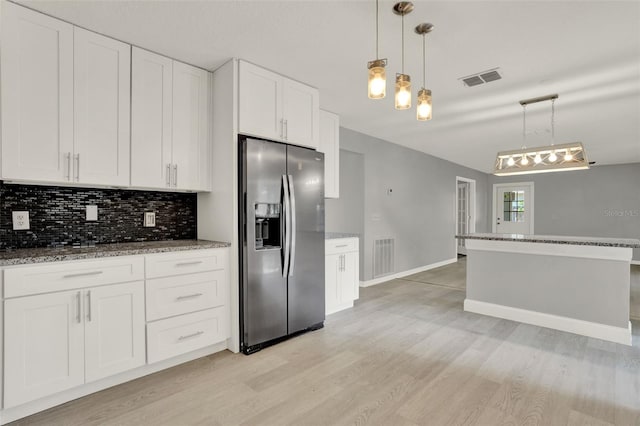 809 Deer Glen Ct, Fruitland Park, FL 34731 - kitchen featuring stainless steel refrigerator with ice dispenser, light wood-type flooring, tasteful backsplash, white cabinets, and stone countertops
