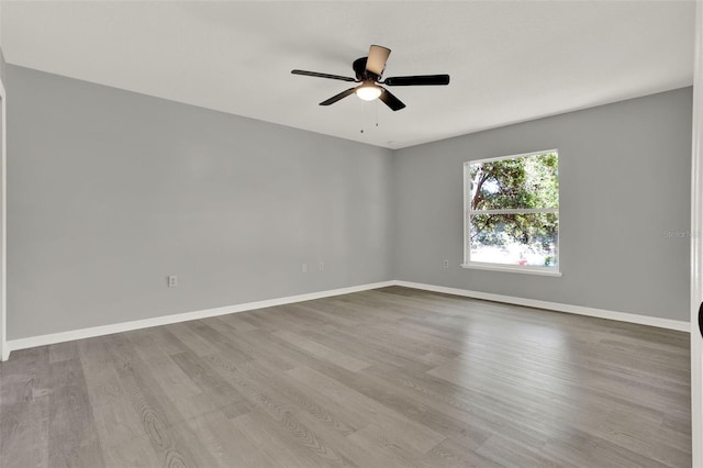 809 Deer Glen Ct, Fruitland Park, FL 34731 - empty room with wood finished floors, ceiling fan, and baseboards